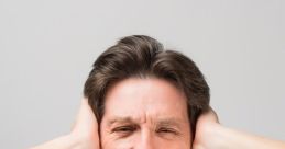 Man in a suit covers ears and screams, expressing frustration in a stressful, annoying situation.