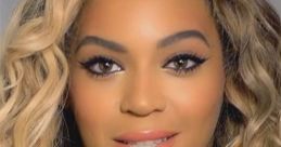 Beyoncé with wavy blonde hair and natural makeup, showcasing her radiant smile and captivating eyes.