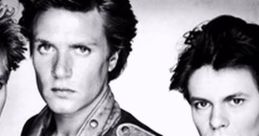 Duran Duran band members pose in a striking black and white photo, showcasing their iconic fashion and style.