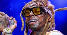 Lil Wayne performs on stage, showcasing his unique style with vibrant clothing, accessories, and a dynamic smile.