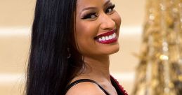 Nicki Minaj smiling in a glamorous black outfit, showcasing her iconic style at a high-profile event.