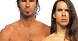 Chad Smith and Anthony Kiedis of the Red Hot Chili Peppers pose confidently, showcasing their unique styles and tattoos.