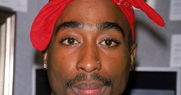 Tupac Shakur with a red bandana and leather jacket, showcasing his iconic style and influence in hip-hop culture.