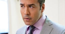 Ari Gold in a stylish suit, looking focused and gesturing, embodies the essence of a top Hollywood agent.