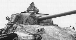 German tank from World War II with crew members on top, showcasing military might in a muddy landscape.