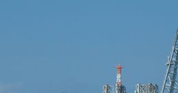 Oil rig structure in open water with a tugboat nearby, showcasing offshore oil extraction and energy resources.