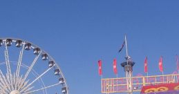 Visitors enjoy lively fairgrounds with a Ferris wheel, rides, and vibrant attractions under a clear blue sky.