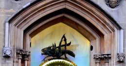 Golden Cambridge clock in archway, showcasing intricate design and craftsmanship, surrounded by historical stonework.