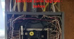 Old electrical panel before upgrade, showcasing wiring and circuit breakers for essential electrical management.