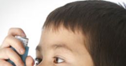 Child using an inhaler to assist with breathing and manage asthma symptoms effectively.