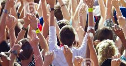 Crowd of enthusiastic fans cheering outdoors with hands raised, celebrating an exciting live event under the sun.