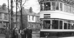 Sheffield Tram No. 189 approaches a stop, with passengers waiting on a tree-lined street. Classic transport scene captured.