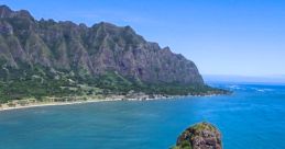 Scenic view of Chinaman's Hat, Oahu, surrounded by turquoise waters and lush mountains, ideal for outdoor activities and relaxation.