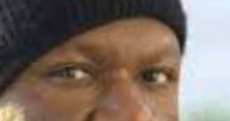 Close-up of an irate Black man wearing a black beanie, showcasing a serious expression and intense gaze.