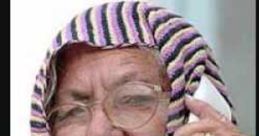 Confused elderly woman in a headscarf, holding a phone, expressing perplexity and curiosity.