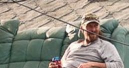 Man lounging on a rooftop in a recliner, enjoying a drink, embodying the relaxed spirit of a Redneck Roofer lifestyle.