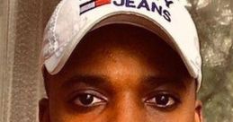 Man with a "Tommy Jeans" cap poses confidently, promoting diversity and cultural acceptance against racism.