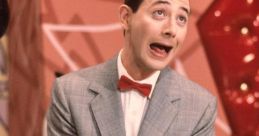 Pee Wee Herman in a playful pose, wearing a gray suit and red bow tie, surrounded by colorful props and a whimsical backdrop.