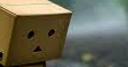 Sad cardboard character standing alone on a wet road, evoking feelings of loneliness and melancholy inspired by Sad FX.