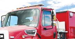 Bright red fire truck on the road, showcasing essential firefighting equipment and marked for the Fire Department FX.