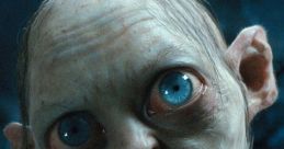 Close-up of Gollum-Smeagol, showcasing his large blue eyes and distinct features in a dark, mysterious setting.