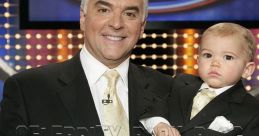 John O'Hurley and baby Dylan pose with a "Family Feud" sign, showcasing a heartwarming moment on the popular game show.