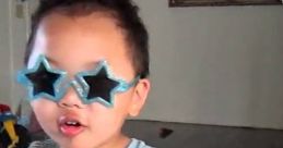 Child with star-shaped sunglasses singing into a microphone, embodying playful energy inspired by Fortnite TROLL vibes.