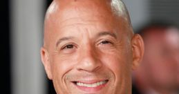 Vin Diesel smiling at a premiere event, showcasing his signature bald look and stylish black attire, exuding charisma.