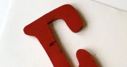 Red wooden letter "E" displayed on a white background, perfect for educational materials or decorative ideas.