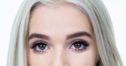 Poppy with striking silver hair and captivating eyes, showcasing her unique style and personality in a minimalist setting.