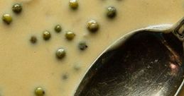 Creamy dish with green peas and a silver spoon, evoking the unique culinary experiences from the Louis Theroux Test.