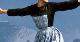 Joyful woman in traditional alpine dress dancing in a scenic mountain landscape, perfect for inspiration and creativity.