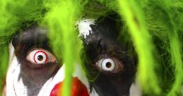 Scary clown with green hair and creepy makeup, featuring sharp teeth and blood, perfect for horror-themed events.