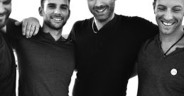 Four friends posing together in casual attire, showcasing camaraderie and joy with a stylish black-and-white backdrop.