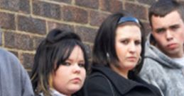 Group of young individuals with serious expressions, standing against a brick wall, embodying a gang-like aesthetic.