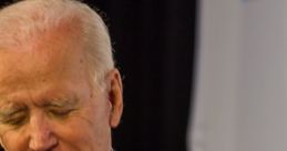 Sleepy Joe Biden appears contemplative, wearing a suit and pink tie during a public event, focused on pressing matters.