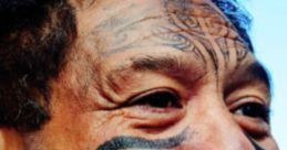 Man with traditional facial tattoos and playful expression showcasing Maori culture, embodying the Crazy Kiwi spirit.