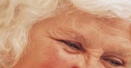 Smiling older woman with white hair, promoting positivity and support in drug and alcohol recovery efforts.