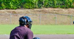 Umpire calls a strike as a baseball catcher prepares, showcasing the intensity of a sunny day at the diamond.