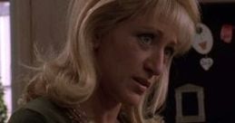 Carmela Soprano in a green top, displaying her signature style and emotional depth from the iconic series "The Sopranos.