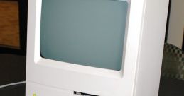 Classic Macintosh computer with keyboard and mouse, showcasing vintage design and early computing technology.