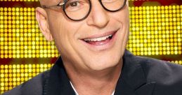 Host Howie Mandel smiling and pointing, promoting excitement for the game show "Deal or No Deal.