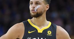 Stephen Curry in a black "The Town" jersey, focused on the game with determination during an NBA matchup.