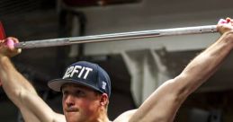 Man performing a snatch lift with a barbell in a gym, showcasing strength and focus in athletic training.