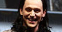 Loki character in dark green and gold attire, showcasing his iconic mischievous smile at a promotional event.