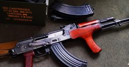 Two Akm rifles with wooden and synthetic grips, surrounded by ammunition boxes and magazines on a green carpet.