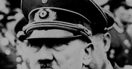 Portrait of Adolf Hitler in military uniform, capturing his stern expression during a public event. Historical significance noted.