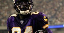 Vikings player celebrating with a football during an NFL game, wearing purple uniform, focused on victory and teamwork.