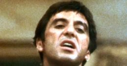 Tony Montana in a bloody suit, showcasing raw emotion in a key scene from Scarface, highlighting the film's intense drama.