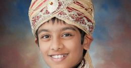 Young boy in traditional Indian bridal attire, adorned with jewelry and a decorative turban, radiating cultural elegance.